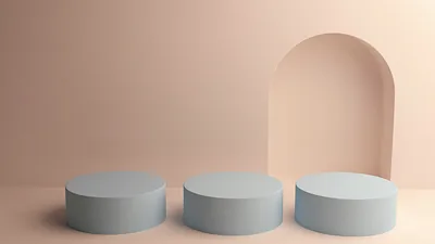 Three empty light blue pedestals in front of an arched doorway on a peach wall.